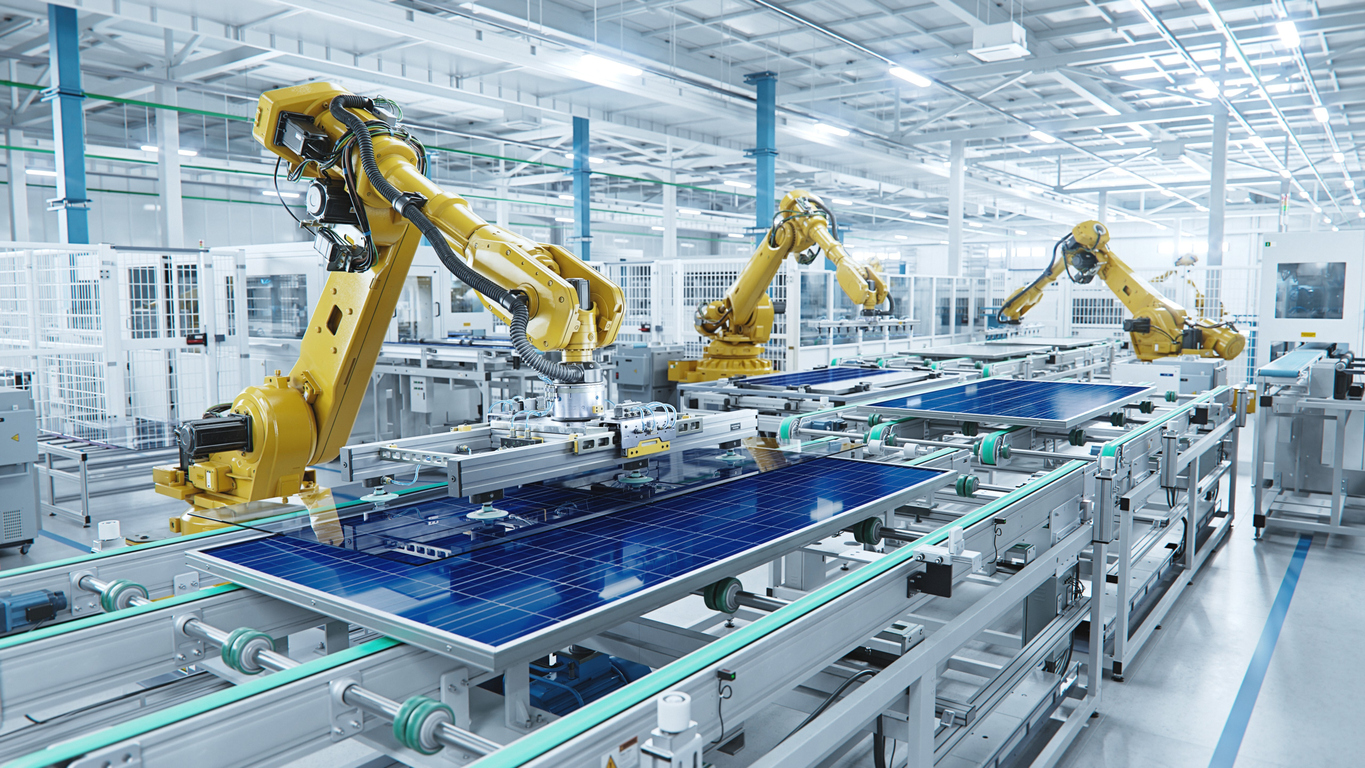 Large Production Line with Industrial Robot Arms at Modern Bright Factory. Solar Panels are being Assembled on Conveyor. Automated Manufacturing Facility